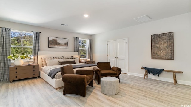 bedroom featuring wood finished floors, multiple windows, baseboards, and recessed lighting