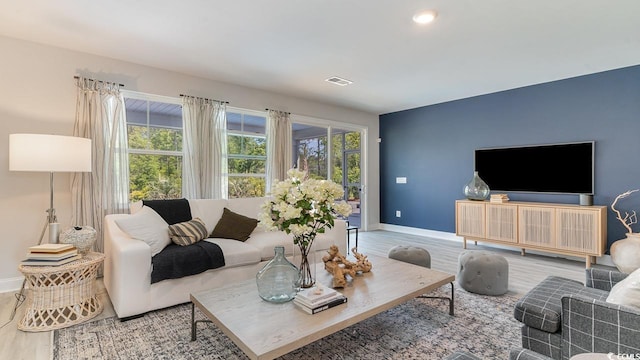 living room with baseboards and wood finished floors