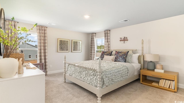 bedroom featuring light carpet and baseboards