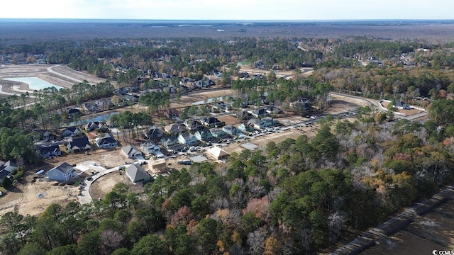 aerial view of property and surrounding area with a forest