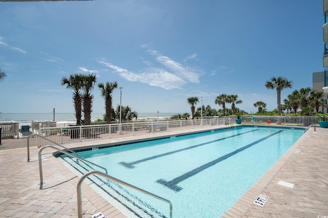 view of swimming pool with a water view