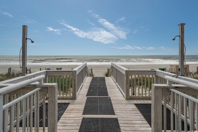 view of community with a beach view and a water view