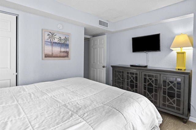 bedroom with wood-type flooring