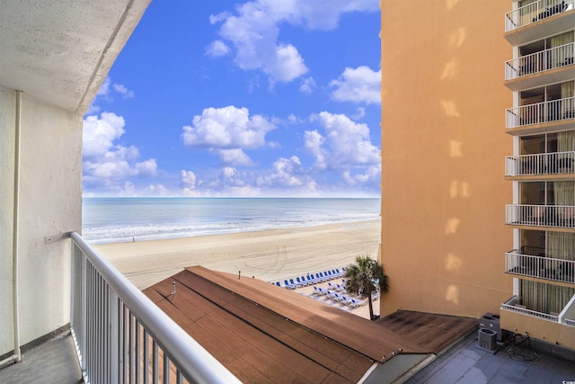 balcony featuring a water view and a view of the beach