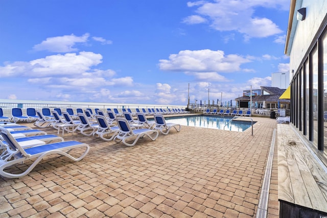 view of swimming pool with a patio