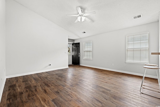 unfurnished room with dark hardwood / wood-style floors, ceiling fan, lofted ceiling, and a wealth of natural light