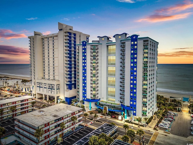 outdoor building at dusk featuring a water view