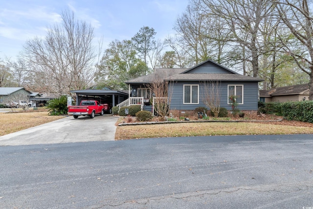 ranch-style house featuring covered porch and a carport