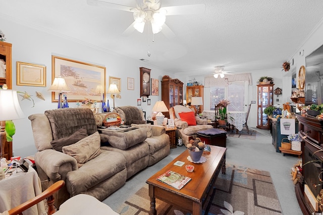 living room featuring light carpet, a textured ceiling, ceiling fan, and ornamental molding