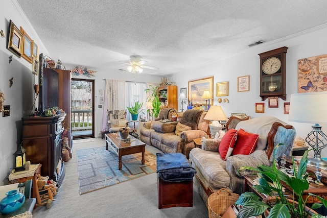 carpeted living room featuring ceiling fan, a textured ceiling, and ornamental molding