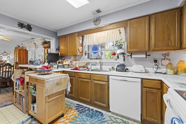 kitchen with stove, white dishwasher, crown molding, sink, and a textured ceiling