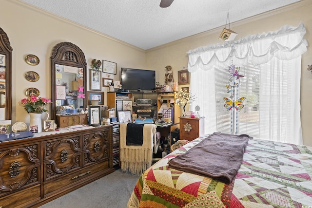 bedroom with a textured ceiling, carpet floors, ceiling fan, and ornamental molding