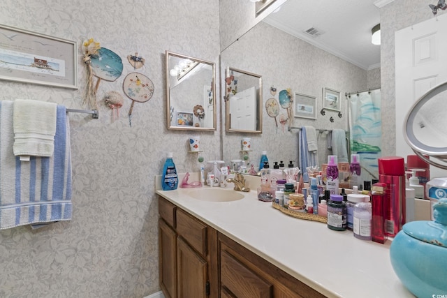 bathroom with a shower with curtain, crown molding, vanity, and a textured ceiling