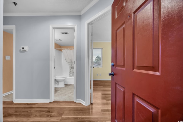 hall featuring hardwood / wood-style floors and ornamental molding