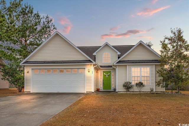 view of front facade featuring a yard and a garage