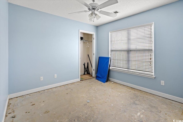 unfurnished bedroom with a textured ceiling, a closet, and ceiling fan