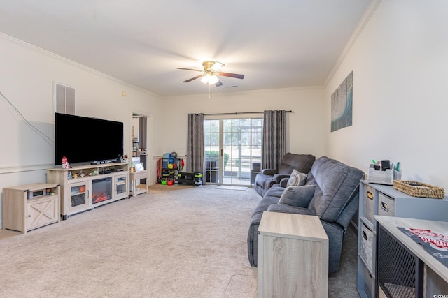 carpeted living room featuring ceiling fan and ornamental molding