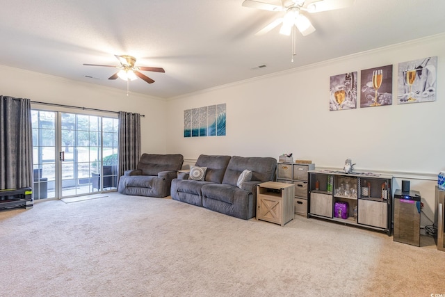 carpeted living room featuring ceiling fan and ornamental molding