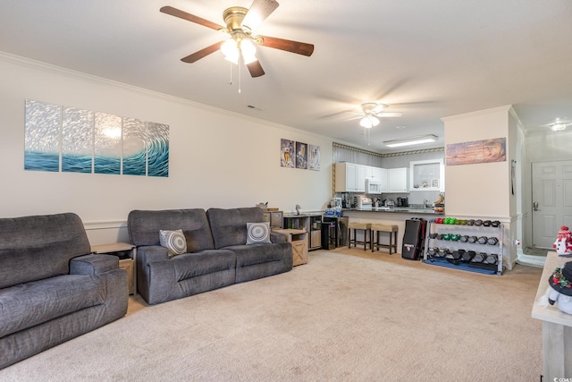 carpeted living room with ceiling fan and crown molding