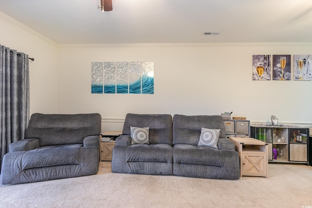 living room featuring carpet flooring, ceiling fan, and ornamental molding