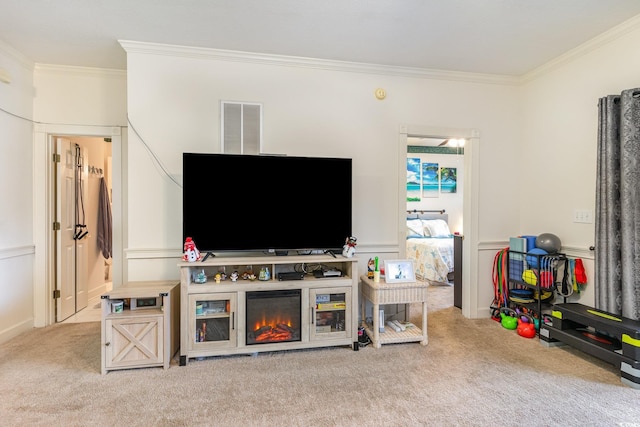 living room featuring a fireplace, light colored carpet, and crown molding