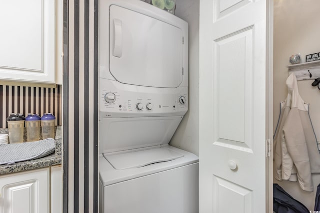 laundry room with stacked washer / dryer