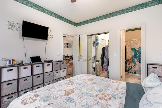 bedroom with ensuite bathroom, a spacious closet, and a closet