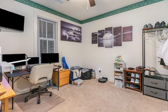 carpeted office space with ceiling fan