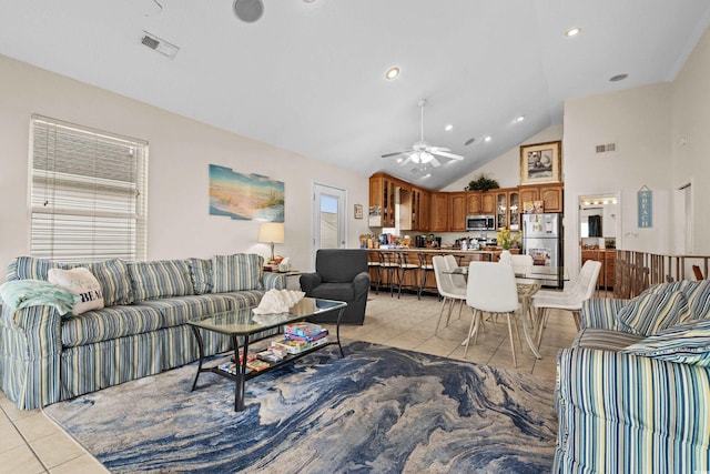 tiled living room with high vaulted ceiling and ceiling fan