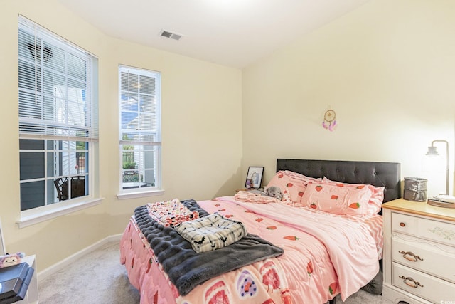 carpeted bedroom with visible vents and baseboards