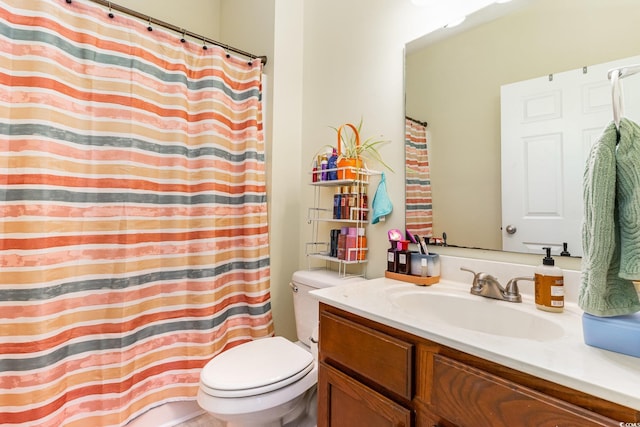 bathroom featuring vanity, a shower with shower curtain, and toilet