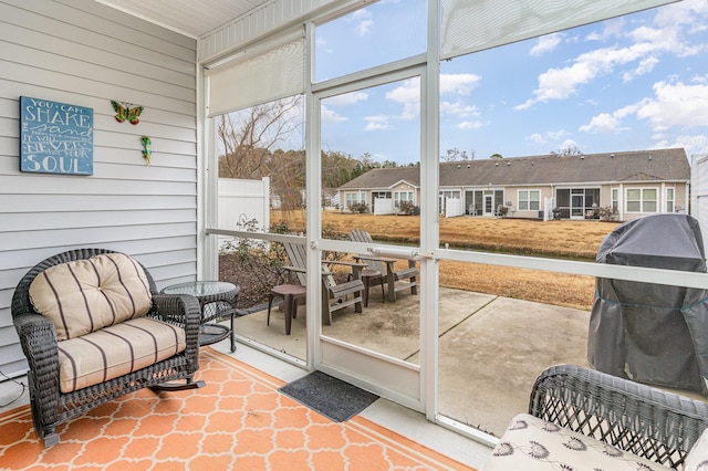 sunroom featuring a residential view