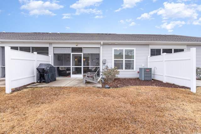 rear view of house with a patio, cooling unit, fence, and a sunroom