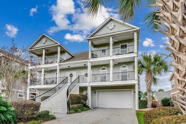 coastal inspired home featuring a balcony and a garage