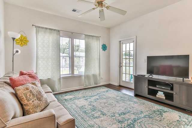 living room featuring dark hardwood / wood-style floors and ceiling fan