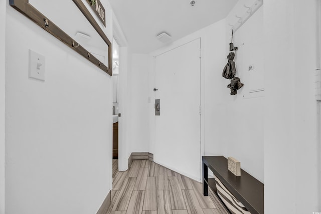 corridor with light hardwood / wood-style flooring