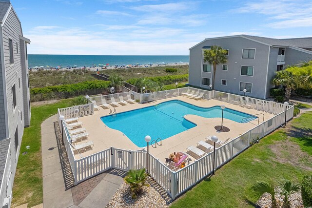 view of pool with a water view and a patio area