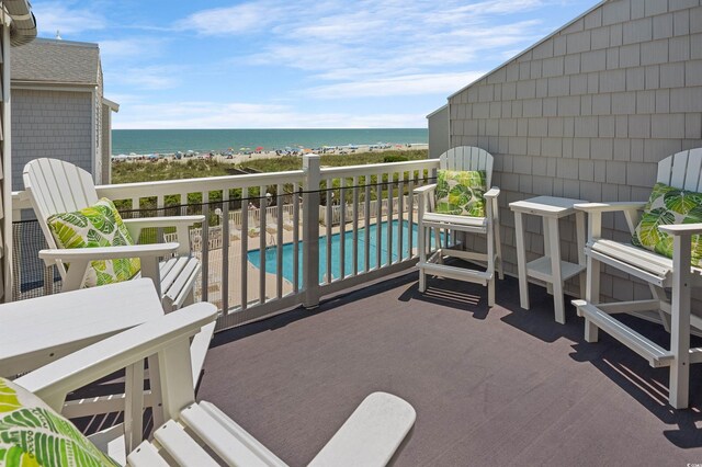 balcony with a view of the beach and a water view