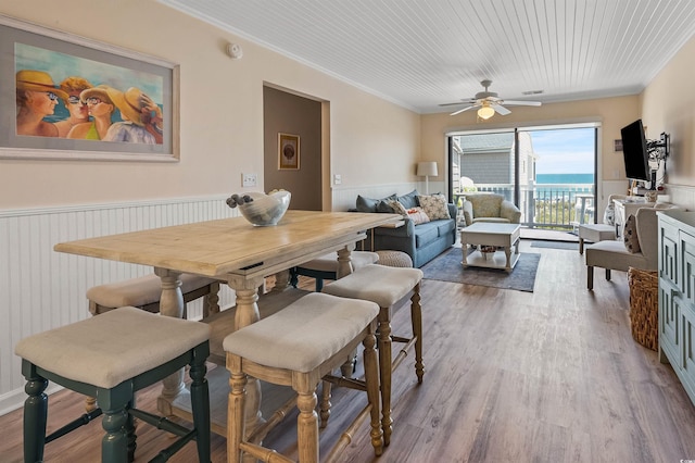 dining area with ornamental molding, hardwood / wood-style floors, and ceiling fan