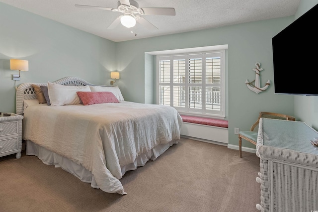 carpeted bedroom featuring a textured ceiling and ceiling fan