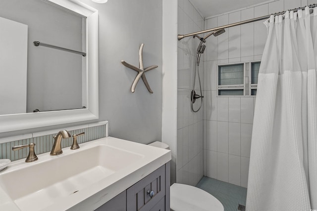 bathroom featuring vanity, curtained shower, and toilet