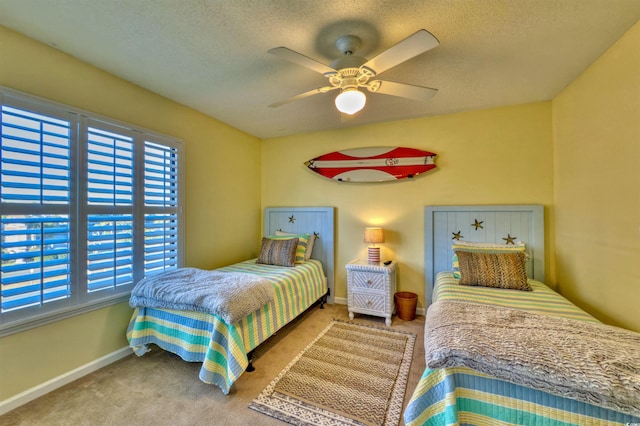 bedroom featuring ceiling fan, light carpet, and a textured ceiling