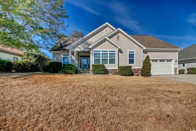 view of front facade with a front yard and a garage