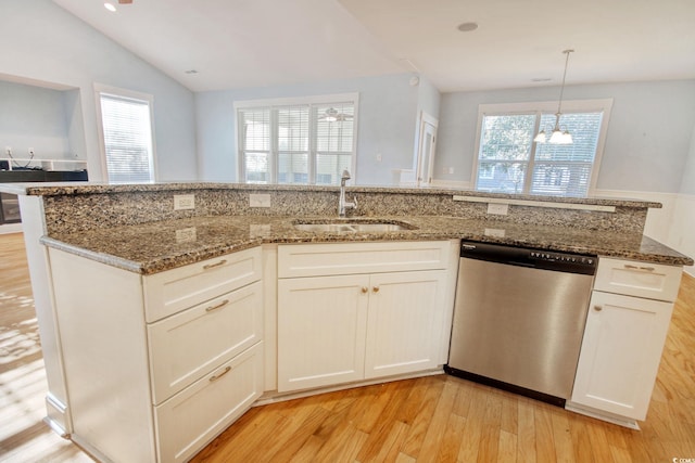 kitchen featuring light wood-style floors, stone counters, dishwasher, and a sink