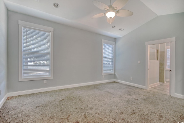 unfurnished room with lofted ceiling, carpet flooring, ceiling fan, and baseboards