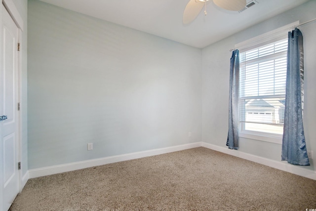 unfurnished room featuring light carpet, ceiling fan, visible vents, and baseboards