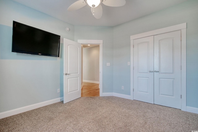 unfurnished bedroom featuring carpet floors, a closet, and baseboards