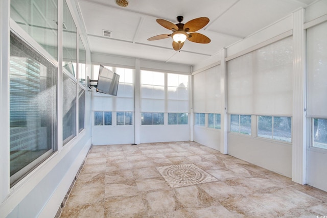 unfurnished sunroom with visible vents and a ceiling fan