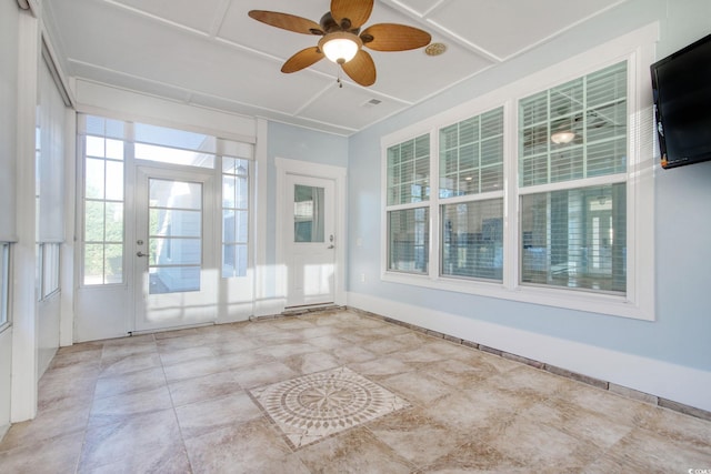 unfurnished sunroom with ceiling fan