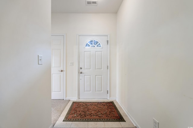 doorway featuring light tile patterned flooring